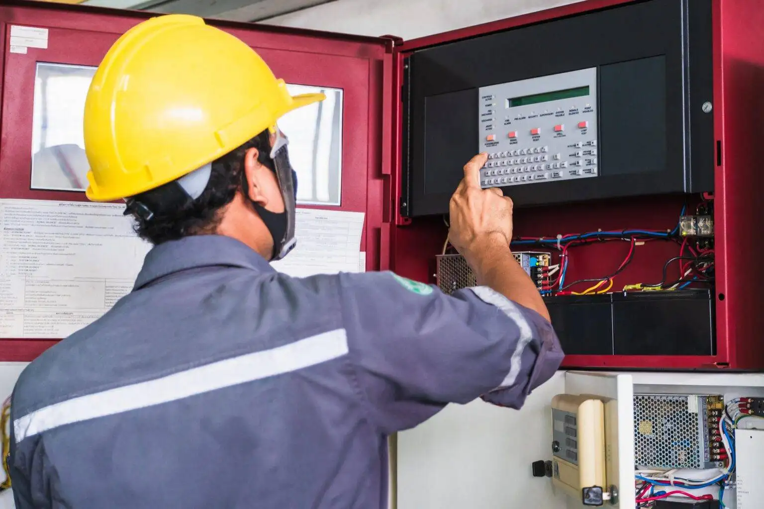 Worker technician working on fire alarm system 1536x1024 1